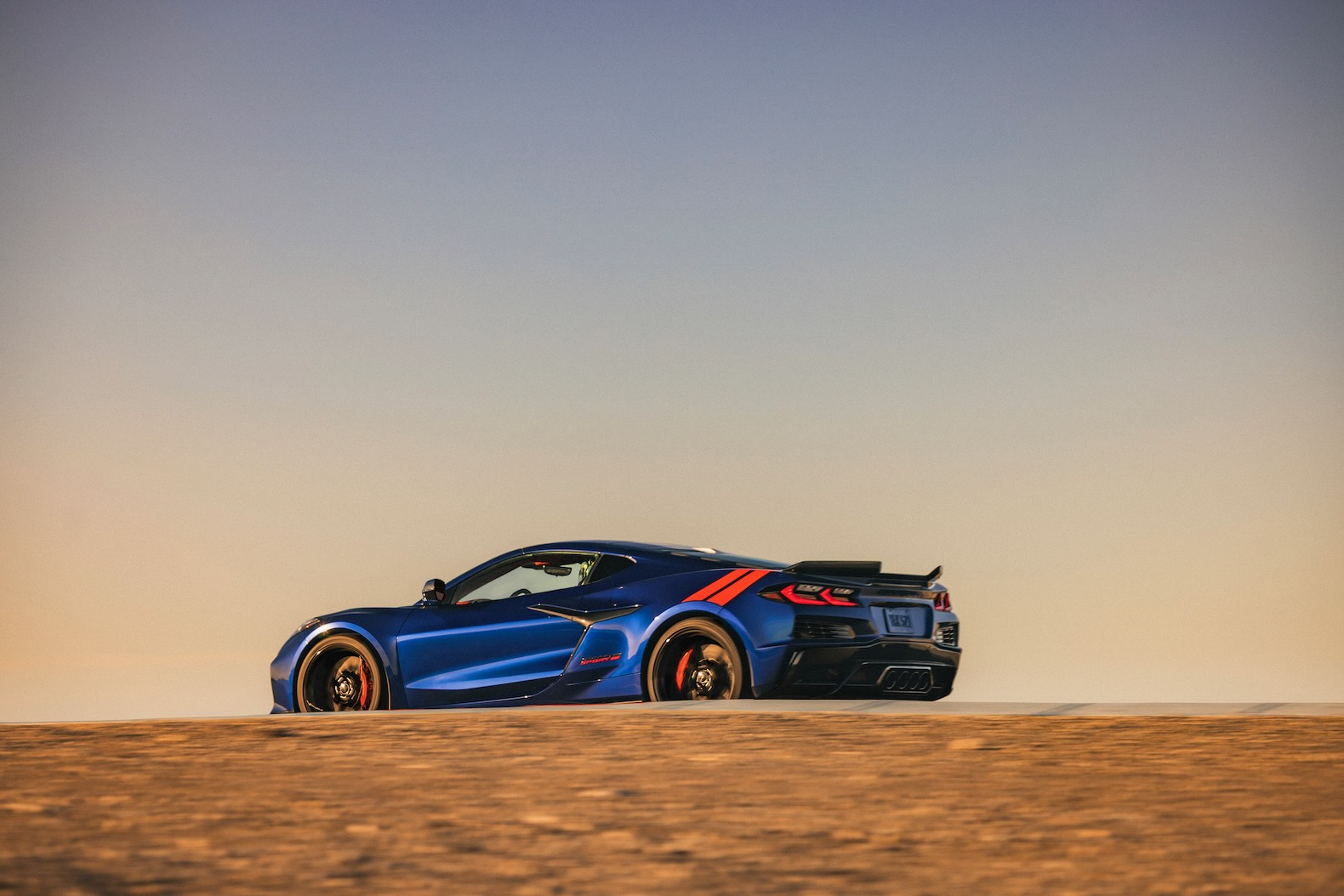 A rear 3/4 view of the 2027 Chevrolet Corvette Grand Sport in Admiral Blue Metallic